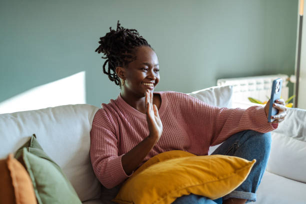 istock Woman enjoying a video call on her smartphone while relaxing at home 2194227334