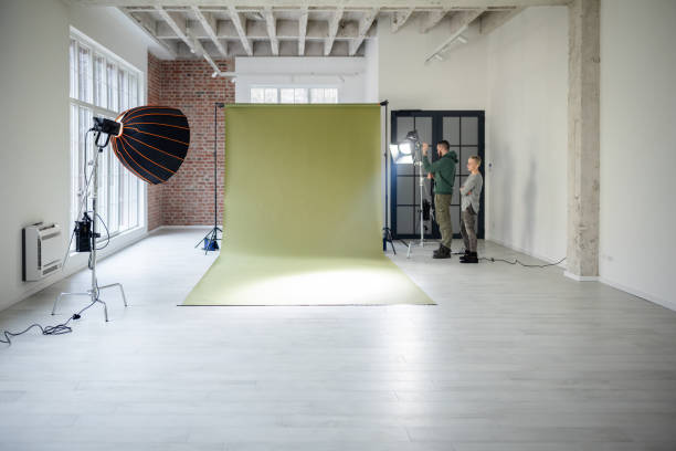 istock Photographer adjusting lights for green background 2194227434