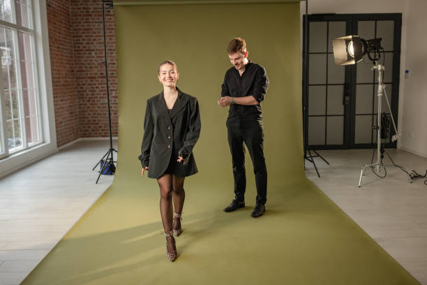 istock Photographer and model share a moment in studio 2194227497