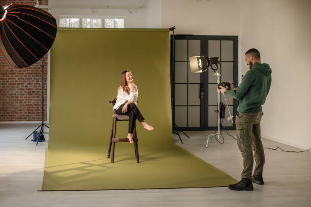istock Photographer captures model in front of green backdrop 2194227524