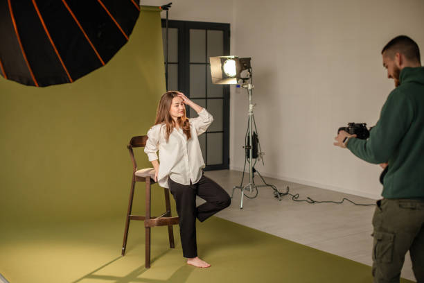 istock Photographer captures woman in creative studio setup. 2194227654