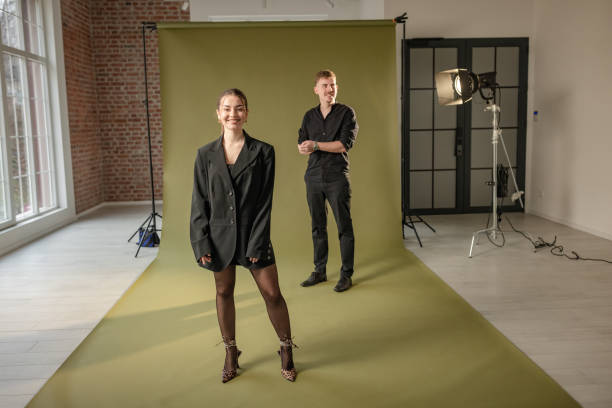 istock Photographer observes model in creative photoshoot 2194227890