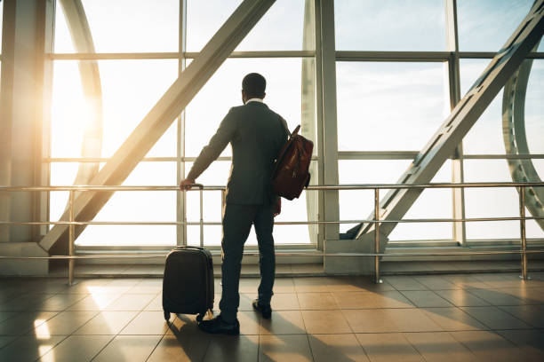 istock Businessman at Airport Terminal Boarding Gate Looking Through Window 2194228431