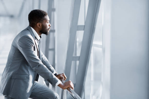 istock Feeling Relaxed. Confident Businessman Looking Through Window 2194228466