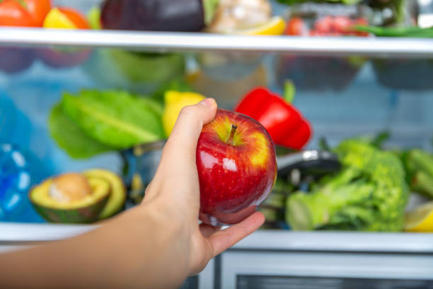 istock Variety of Fresh Fruits and Vegetables Displayed Inside a Modern Refrigerator 2194228489