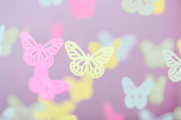 Delicate and enchanting butterfly patterns in lovely pastel colors adorn a soft backdrop, ideal for spring designs and baby theme