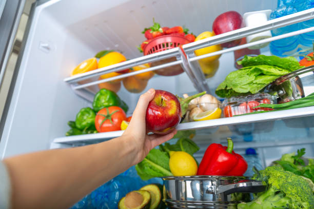 istock Variety of Fresh Fruits and Vegetables Displayed Inside a Modern Refrigerator 2194228544
