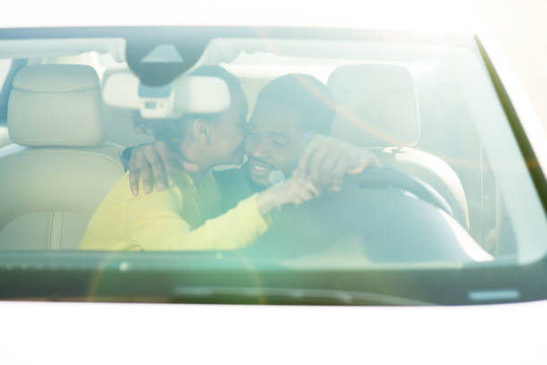 Hand of man driving inside car selective focus.