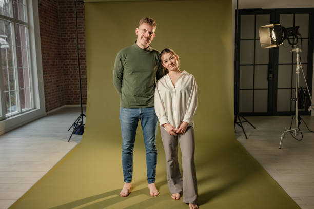 istock Smiling couple posing in professional photo studio setup 2194229834