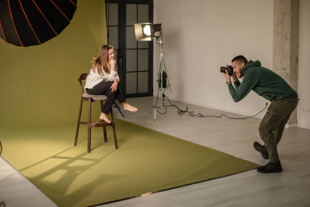 istock Smiling model poses for photographer in photo studio 2194229895