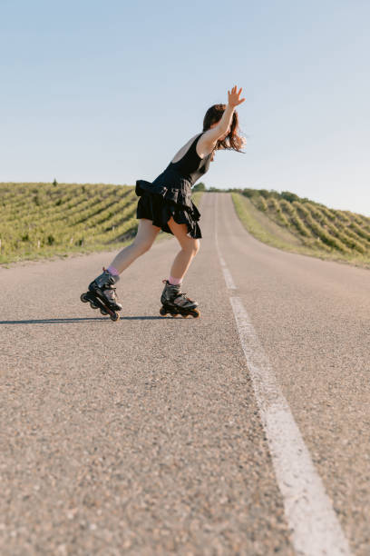 istock Young woman roller skating outdoors on sunny summer day 2194230077
