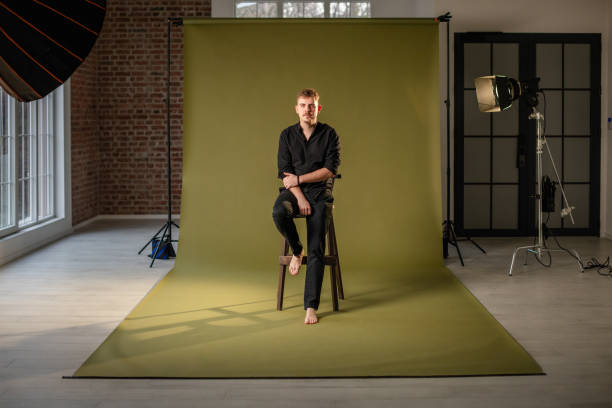 istock Studio portrait of seated man on wooden stool 2194230303