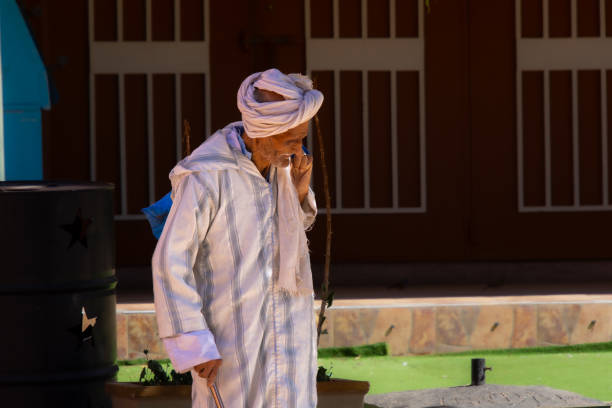 Old Moroccan man walking in the city of Tafraout in Morocco