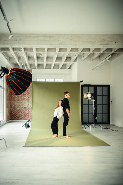 istock Stylish couple in dynamic studio photoshoot session 2194230559