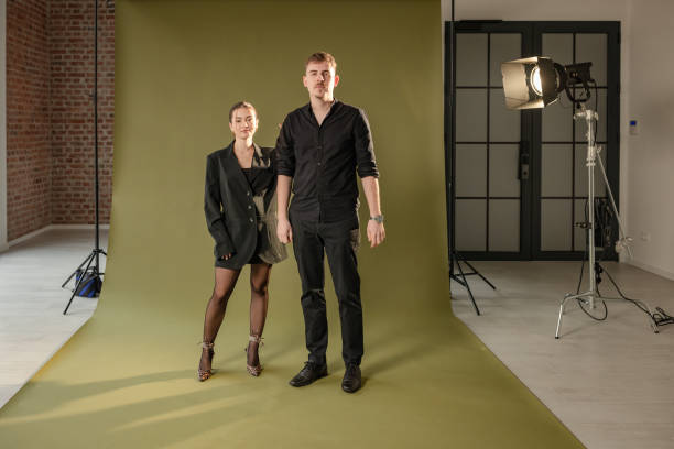 istock Stylish man and woman pose in contemporary studio. 2194230693