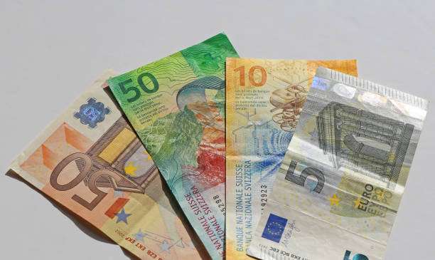 istock Euro and Swiss Franc banknotes with white background 2194231074
