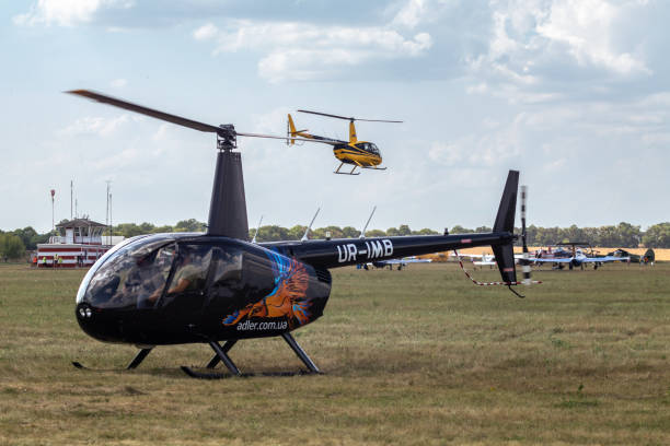 Kharkiv, Ukraine - August 29, 2021: Helicopter Robinson R44 Raven II on grass field at KharkivAviaFest airshow