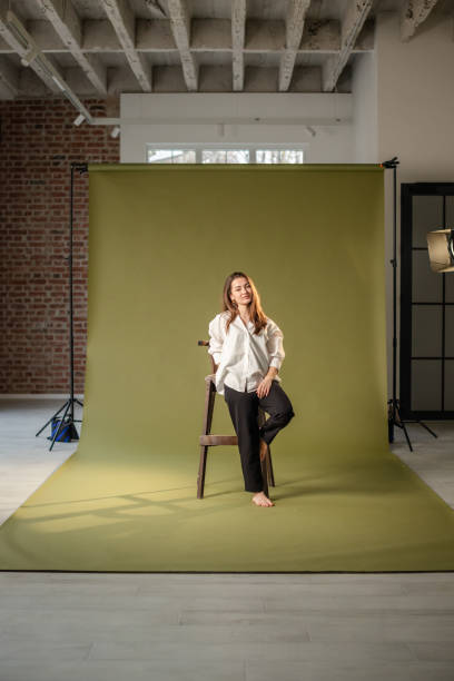 istock Woman posing on chair demonstrating peaceful demeanor. 2194231656