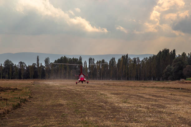 A modern, closed-cabin, pusher-propeller autogyro in flight