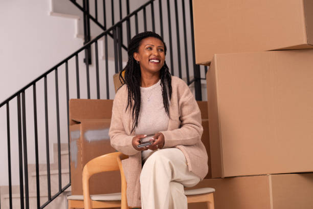 istock Smiling Woman Relaxing During a Busy Moving Day. 2194231750
