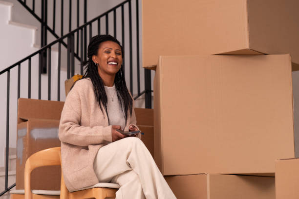 istock Smiling Woman Taking a Break During Moving Day. 2194231751