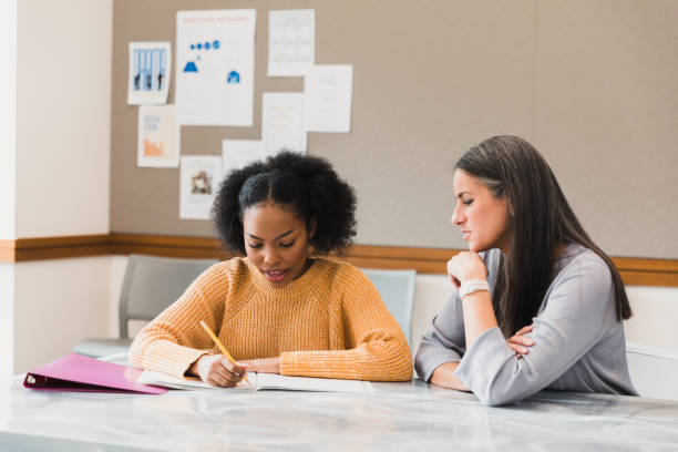 istock Tutoring session: young woman receiving help and support 2194233413