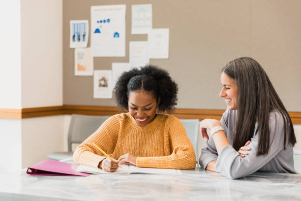 istock Happy young woman student studying with a teacher 2194233433