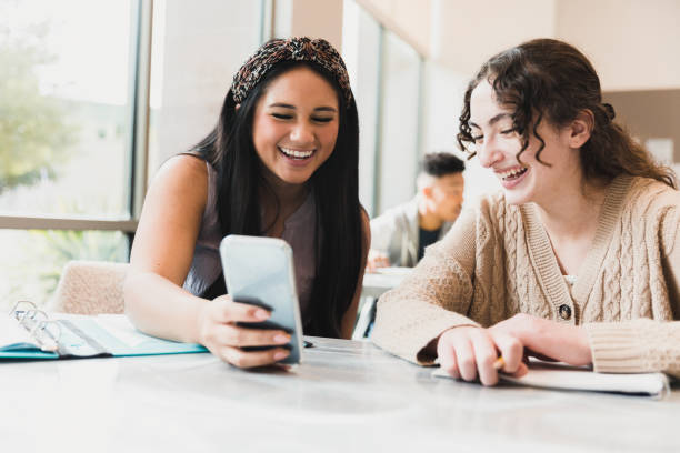 istock Two happy high school girls using a smartphone together 2194233462