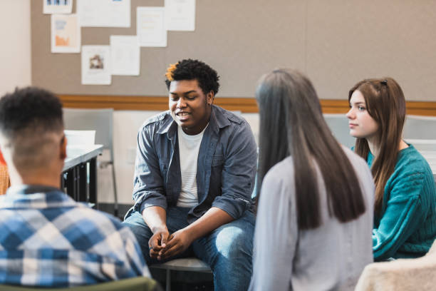 istock Diverse Group of Students in a Classroom Discussion 2194233556
