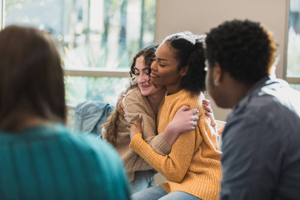 Young Women Embracing in Group Therapy Session