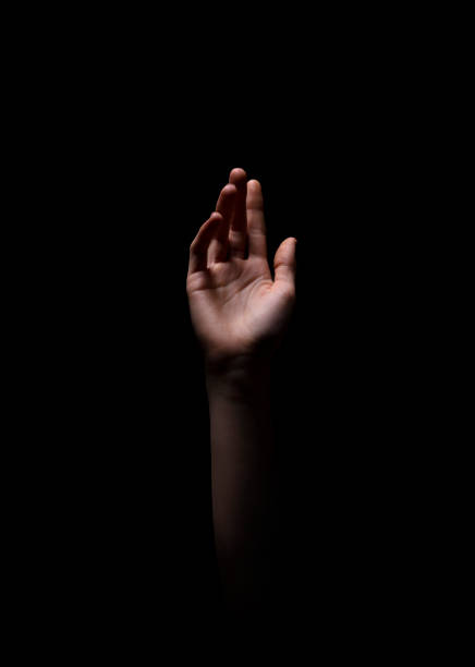 istock Hand Reaching out in Darkness Symbolizing Hope and Longing for Connection 2194236231