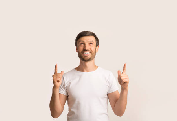 istock Man Pointing Fingers Upward, White Background, Studio Shot 2194237030