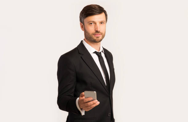 istock Businessman Holding Mobile Phone Standing Over White Background 2194237089