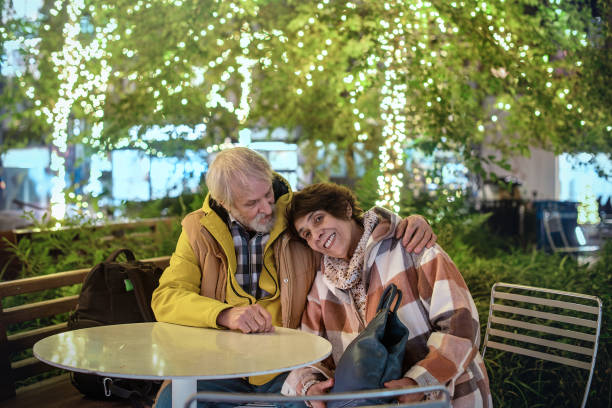 istock Senior couple shares intimate evening under illuminated trees 2194238061
