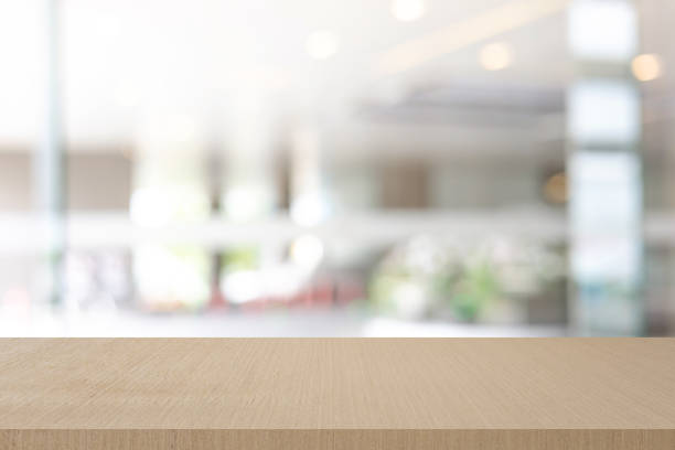 istock Abstract blurred modern interior office room background with perspective wood tabletop for show, promote and design content or product on display concept 2194238719