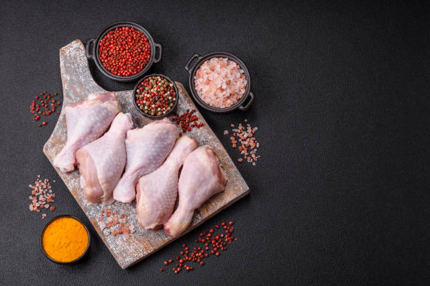 istock Raw chicken legs with salt, spices and herbs 2194238955