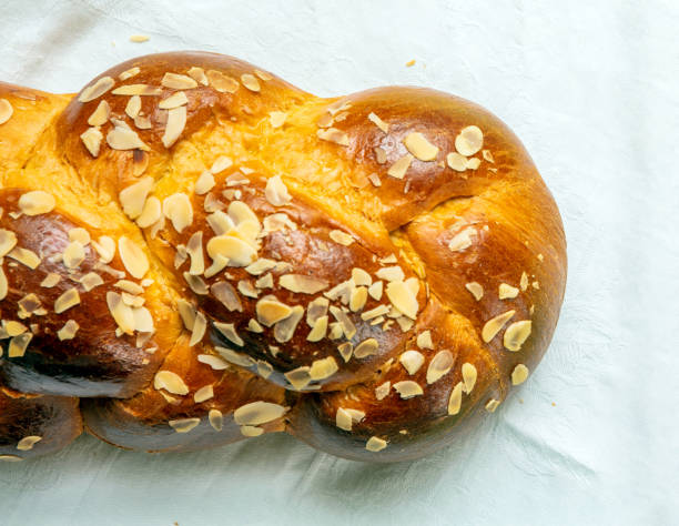 istock Easter bread, greek tsoureki braid on white table cloth, top view 2194240089