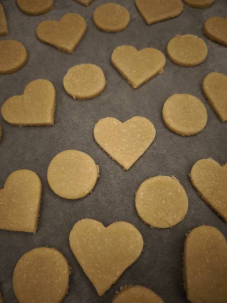 istock Heart and circle shaped cookies baking on parchment paper for valentine's day 2194241989