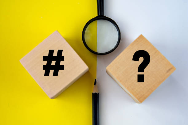 istock Hashtag and question mark on wooden cubes on a yellow and white background. 2194242360