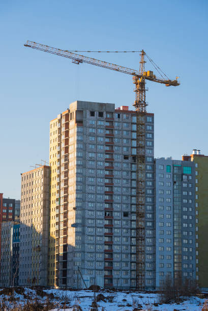 istock Construction crane building new apartment residential building in modern district 2194242444