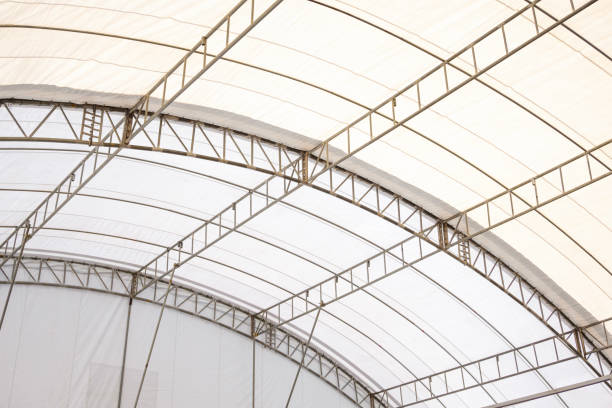 istock Metal roof beam structure with canvas of large dome event tent, low angle and inside view 2194242790