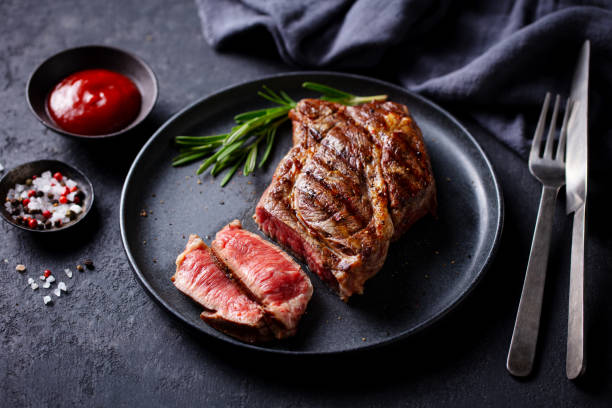 istock Beef Steak medium rare on a black plate. Dark grey background. Close up. 2194243540