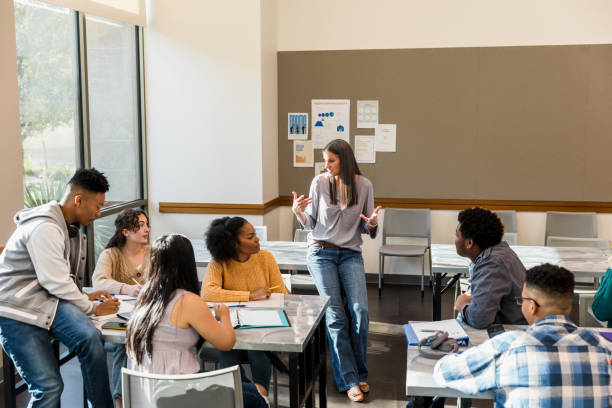 istock Teacher Leading Diverse Group of Students in Classroom Discussion 2194243732
