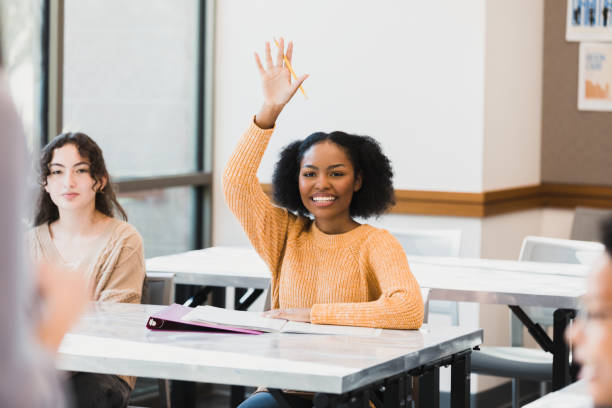 istock Smiling Student Raising Hand in Classroom, Education Concept 2194243736