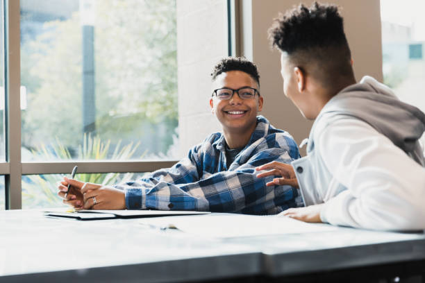 istock Two Teenage Boys Having a Discussion in a Classroom 2194243750