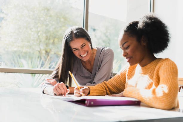 istock Happy Teacher and Student Working Together in Classroom 2194243773