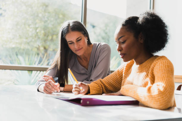 istock Two Women Collaborating, Studying Together in Bright Room 2194243777