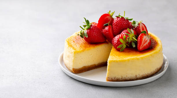 istock Cheesecake dessert with fresh strawberries on a plate. Grey background. Close up. Copy space. 2194244431