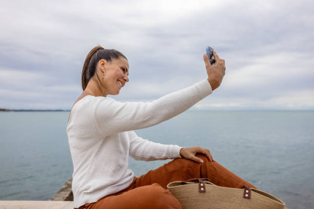 istock Woman Taking Selfie by Sea 2194244799