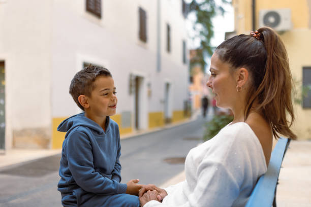 istock Mother and Son Talking on Bench on a Sunny Day 2194244835